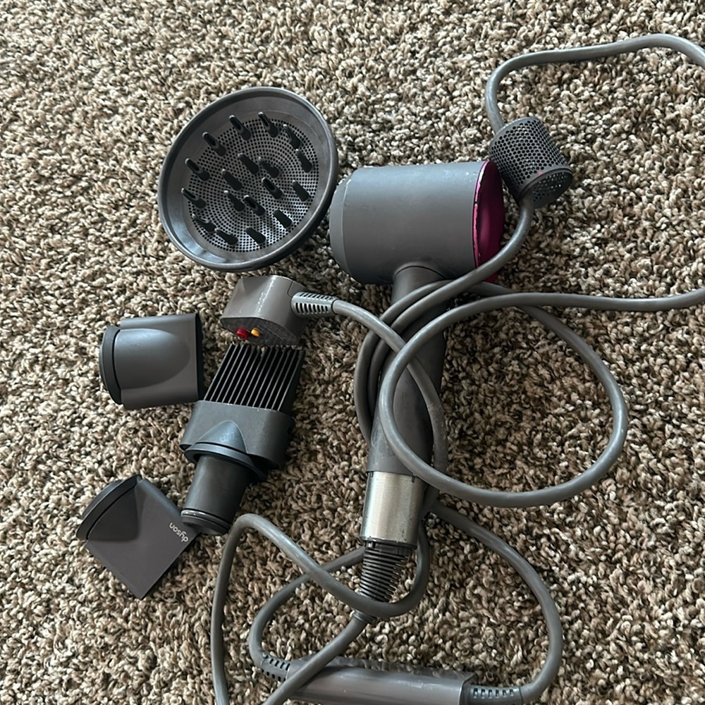 DYSON HAIR DRYER WITH ALL ATTACHMENTS in the photo